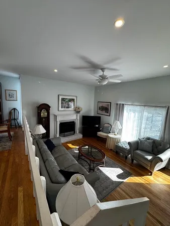 a living room with furniture fireplace and a window