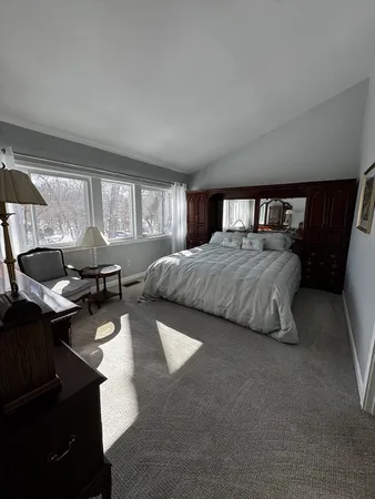 a bedroom with a bed window and couch