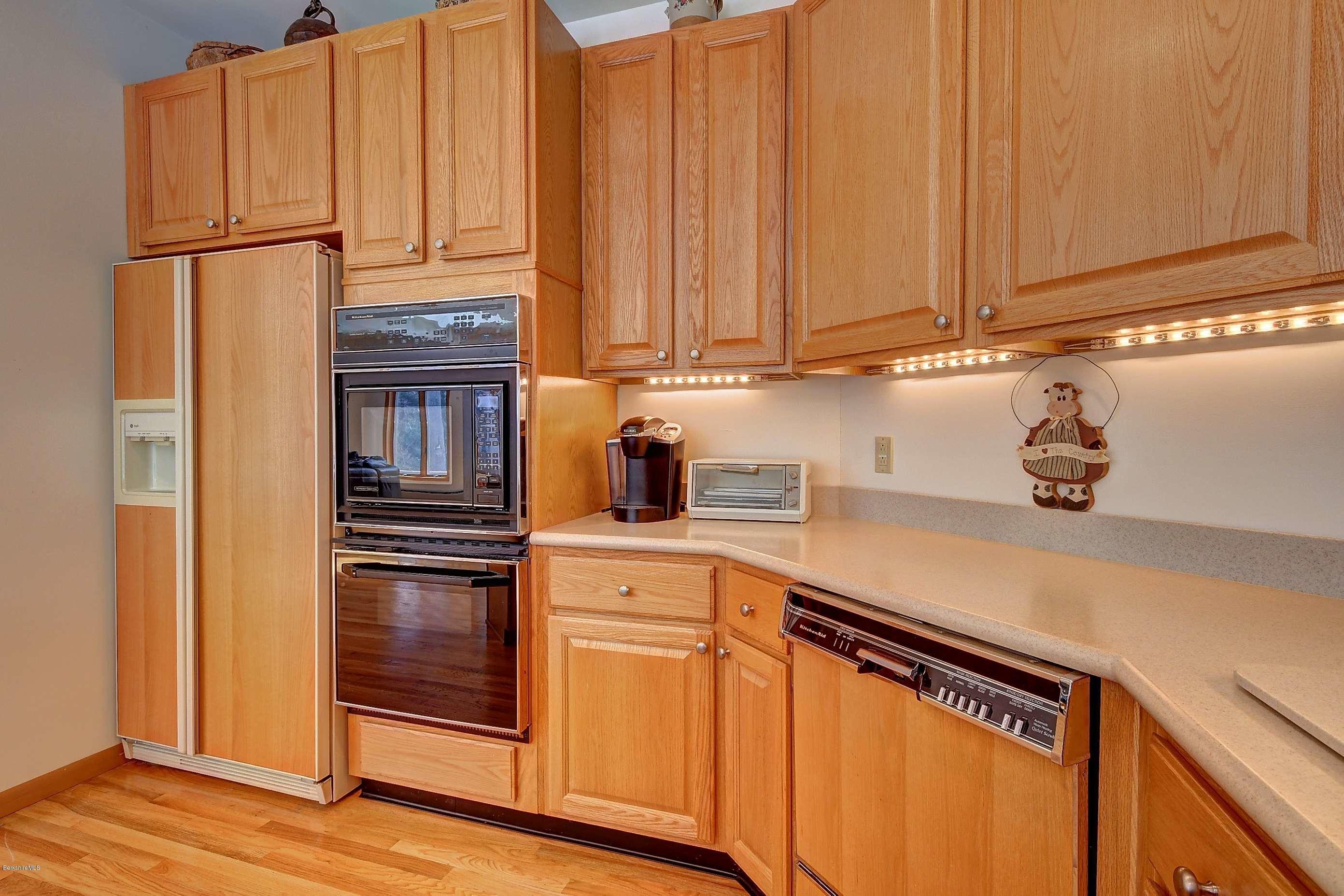 15 Bliven Road Otis, MA 01253 - Photo 14 of 30 a kitchen with stainless steel appliances a refrigerator and cabinets