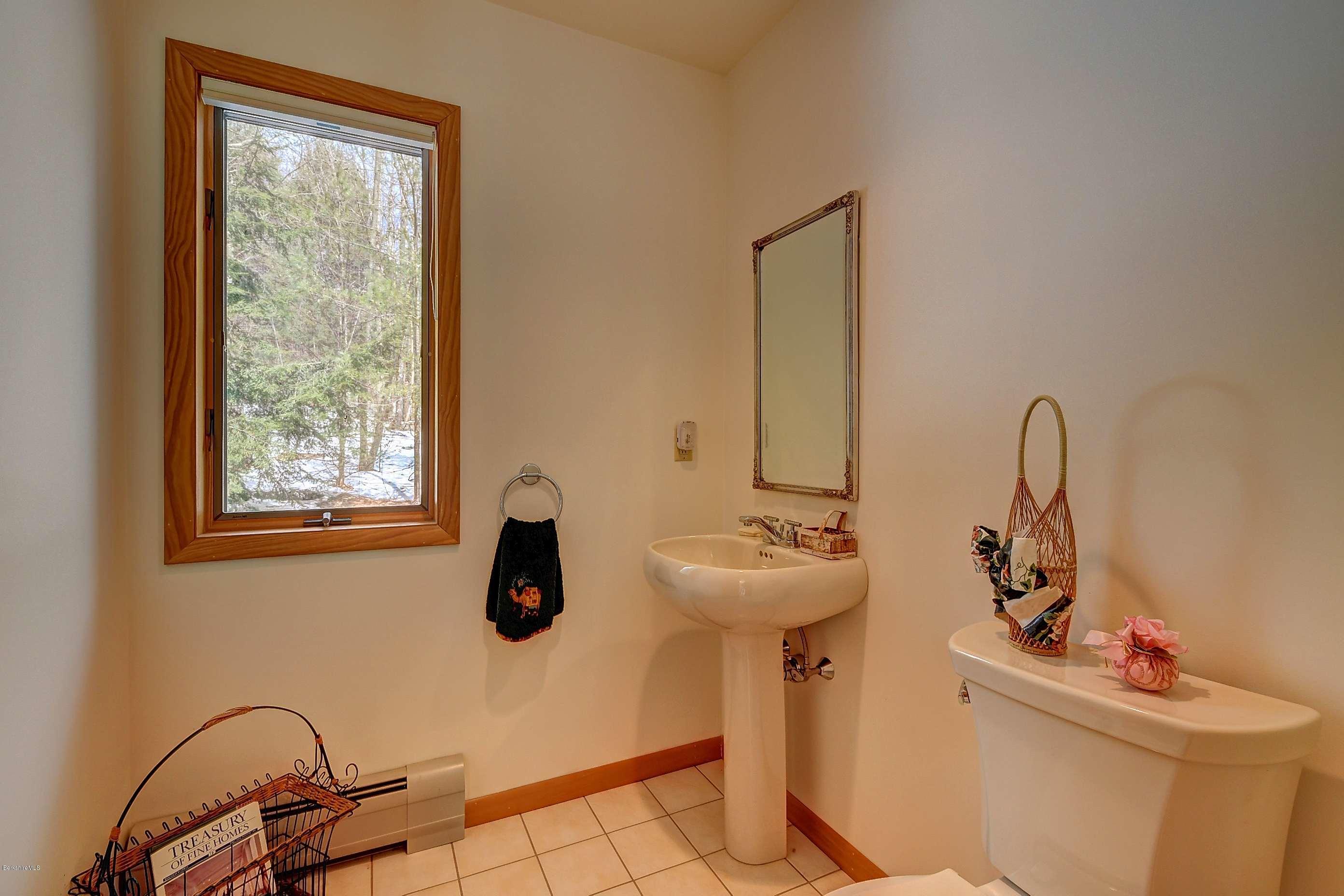 15 Bliven Road Otis, MA 01253 - Photo 25 of 30 a bathroom with a sink and mirror with bathtub