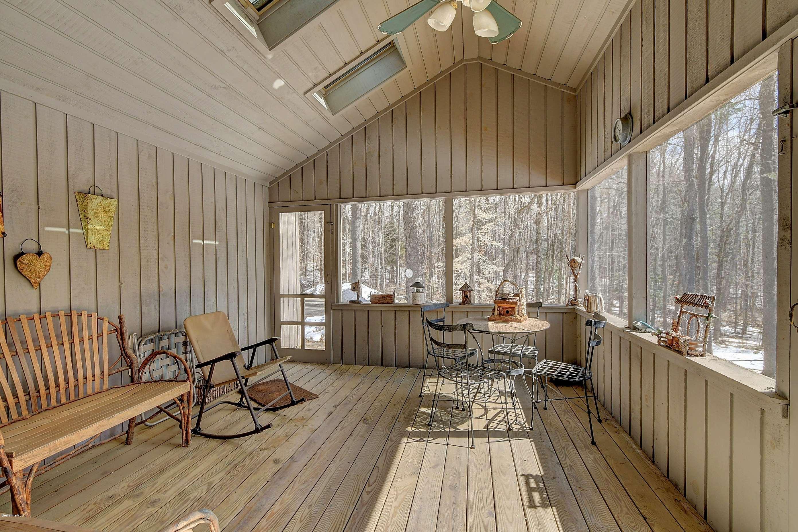 15 Bliven Road Otis, MA 01253 - Photo 26 of 30 a view of a patio with couches table and chairs and wooden floor