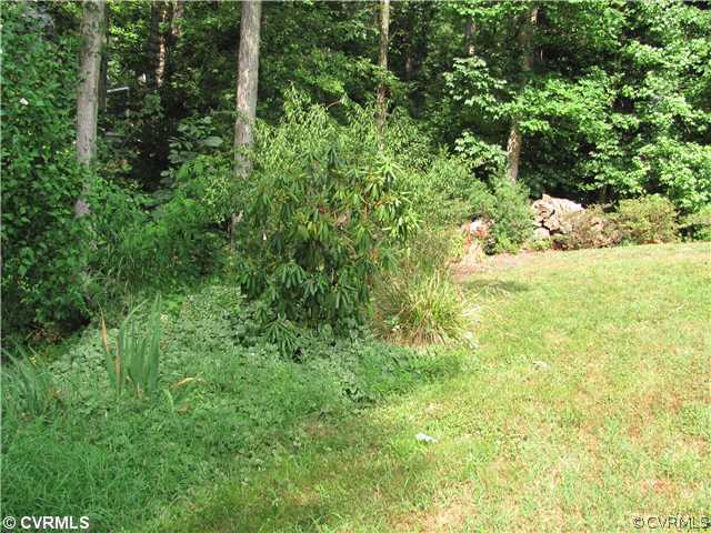 5413 Standing Oak Road Midlothian, VA 23112 - Photo 4 of 12 a view of a yard with plants and large trees