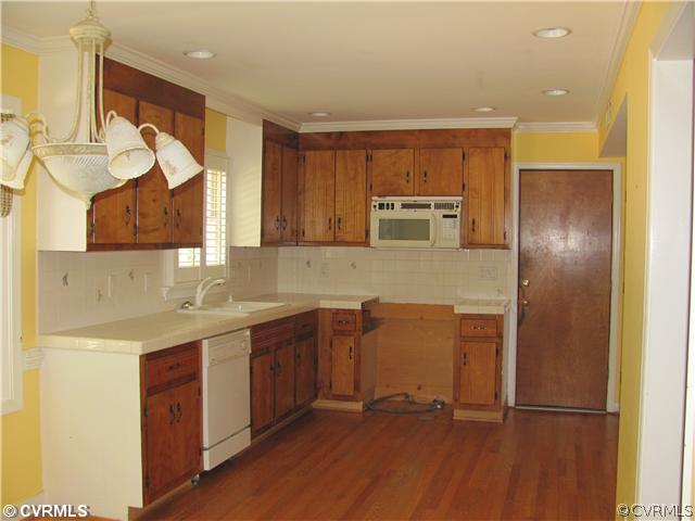 5413 Standing Oak Road Midlothian, VA 23112 - Photo 8 of 12 a kitchen with stainless steel appliances granite countertop a sink and a refrigerator
