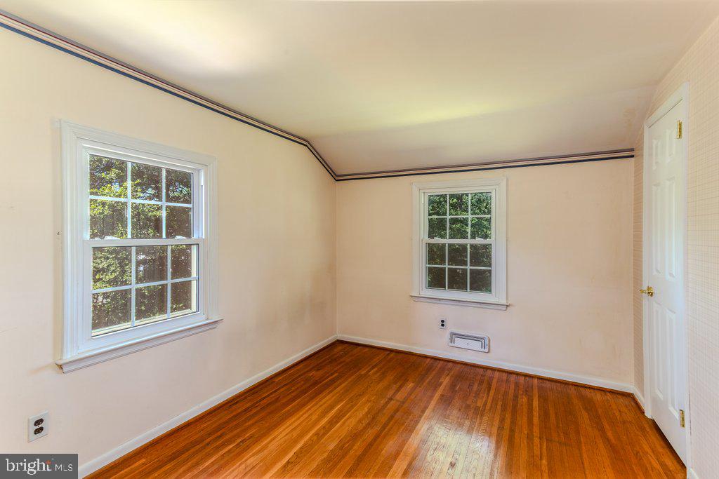 324 Wayland Road Cherry Hill, NJ 08034 - Photo 23 of 28 an empty room with wooden floor and windows
