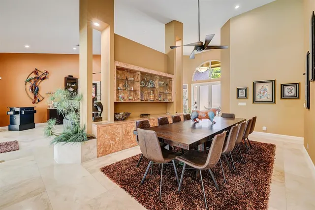 a spacious bedroom with a bed and glass windows