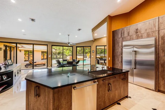 a view of backyard with swimming pool and seating space