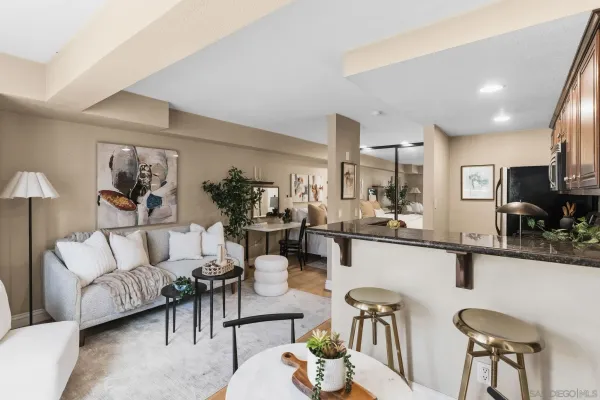a living room with furniture and a kitchen view