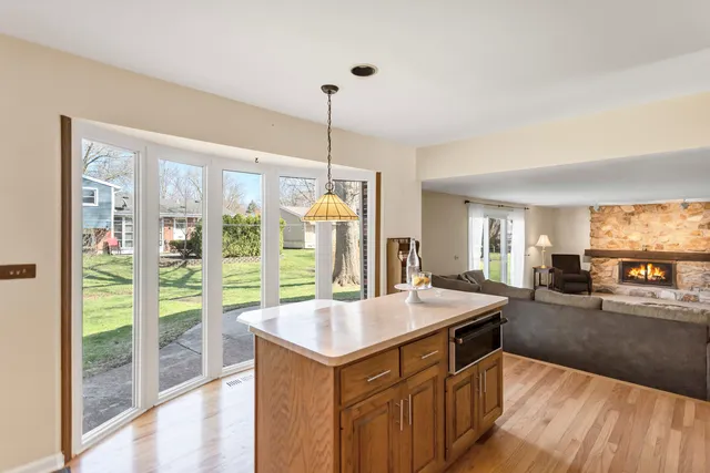 a kitchen with sink refrigerator and large window