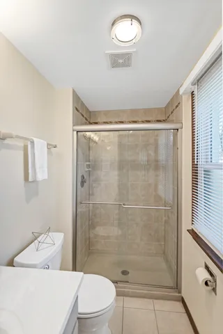 a bathroom with a shower a toilet and a sink