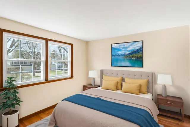 a bedroom with a bed and a painting on the wall