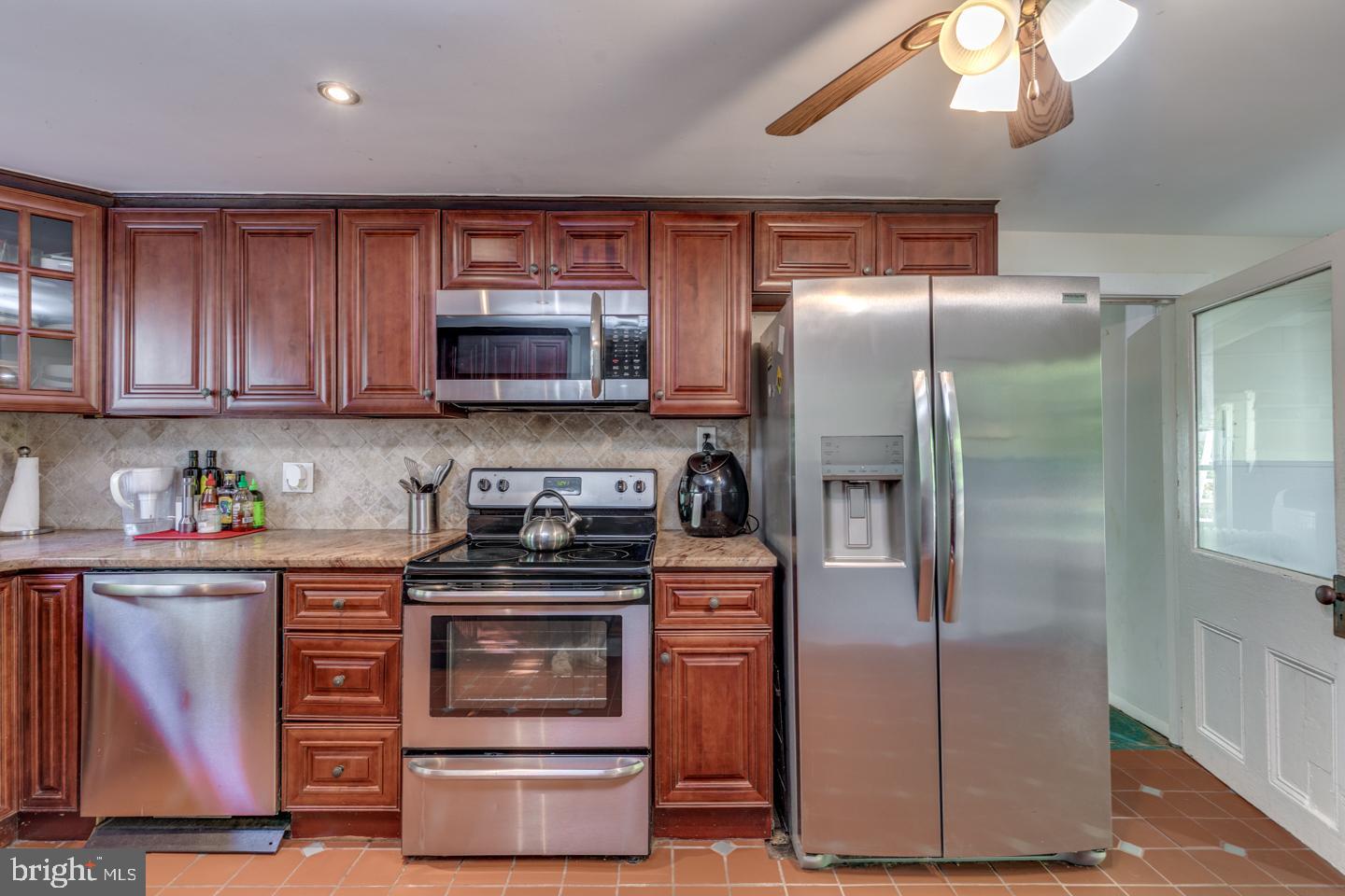 660 South Church Street Mount Laurel, NJ 08054 - Photo 10 of 55 a kitchen with stainless steel appliances granite countertop a refrigerator a stove and a sink with wooden cabinets