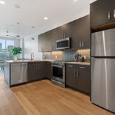 a kitchen with a refrigerator a sink and cabinets