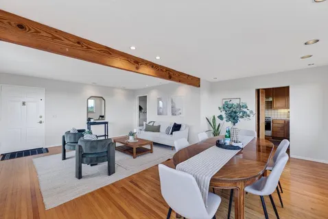 a dining room with furniture and wooden floor