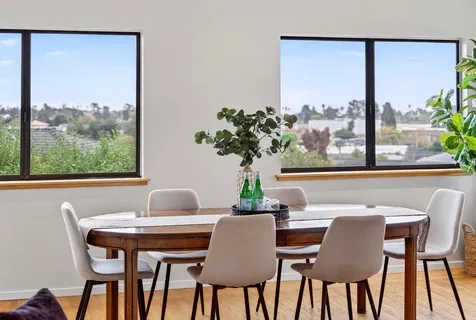 a dining room with furniture and window