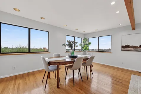 a view of a dining room with furniture window and wooden floor