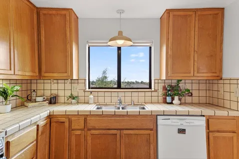 a kitchen with a sink cabinets and window