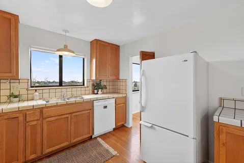 a kitchen with stainless steel appliances a refrigerator sink and cabinets