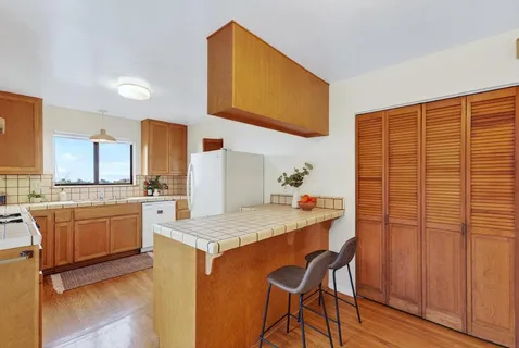 a kitchen with stainless steel appliances granite countertop wooden cabinets a stove a sink and dishwasher
