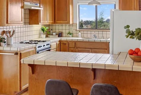 a kitchen with stainless steel appliances granite countertop a sink a stove counter space and cabinets