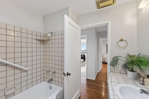 a bathroom with a bathtub shower sink and toilet