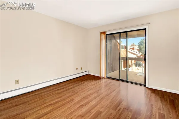 a view of an empty room with wooden floor