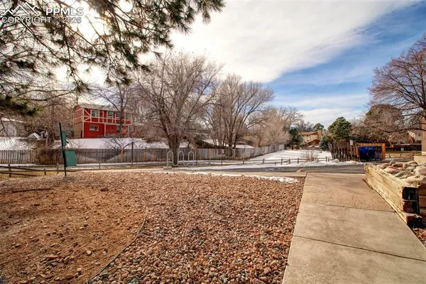 a view of a yard with snow on the road