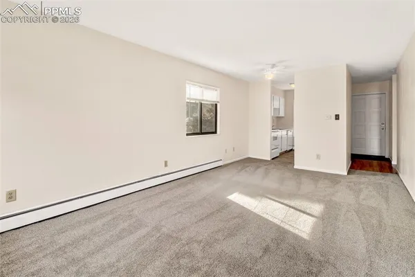 an empty room with windows and closet