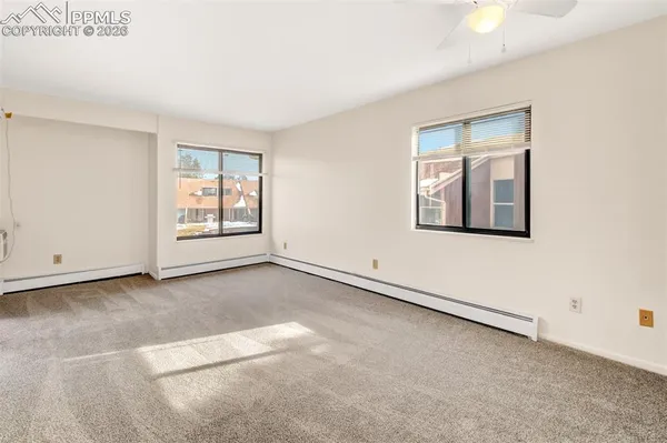 an empty room with windows and closet