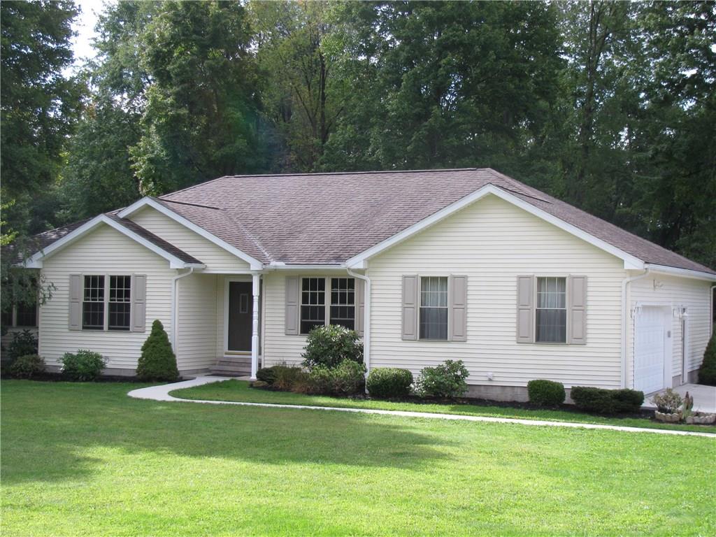 VINYL SIDED RANCH 10 YEARS YOUNG WITH NEW CEMENT DRIVE AND SIDEWALK.  FIRST FLOOR LAUNDRY 3 CAR ATTACHED GARAGE W/2 DOORS ONE EXITING TO REAR YARD.