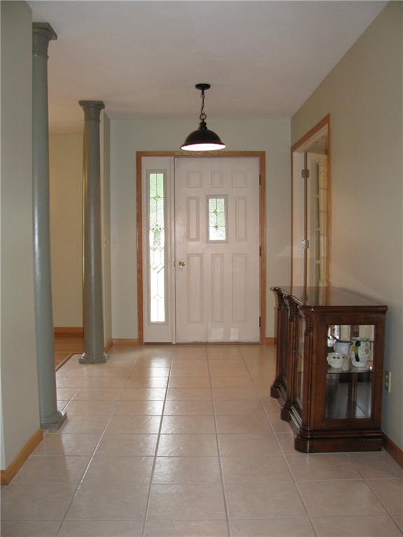 161 Donation Road Greenville, PA 16125 - Photo 2 of 25 FORMAL FOYER WITH TILE FLOORING AND FLOOR TO CEILING PILLARS ACCENTING THE FORMAL D.R. FORMAL L.R./DEN ON OPPOSING WALL.