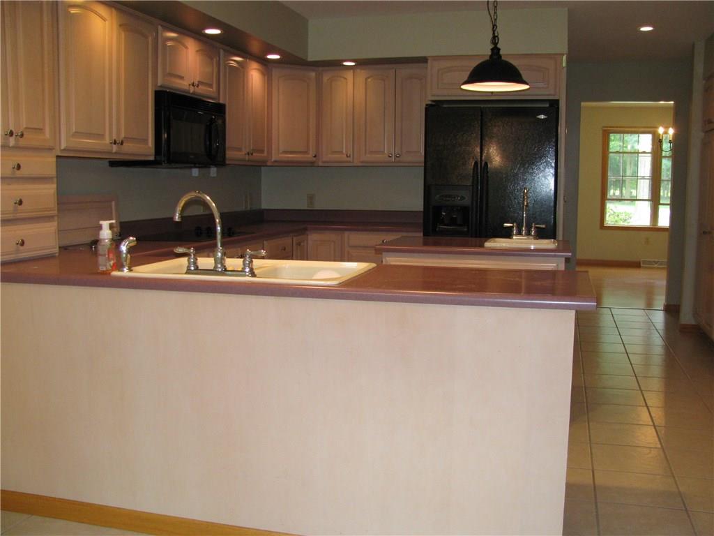 161 Donation Road Greenville, PA 16125 - Photo 12 of 25 LIGHT WOOD CABINETRY KITCHEN WITH ADDITIONAL ISLAND AND PREP SINK FOR DUAL "CHEFS"