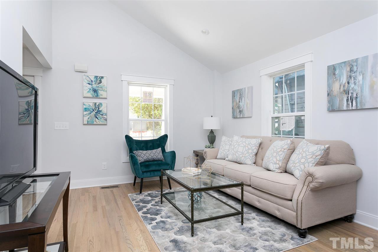 111 Bart Street Raleigh, NC 27610 - Photo 11 of 22 a living room with furniture and a wooden floor