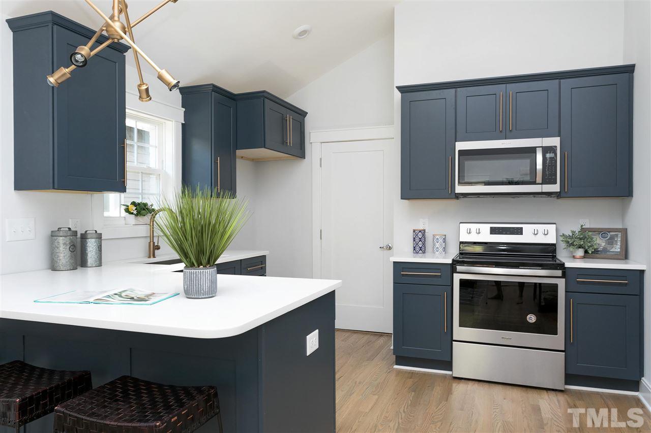 111 Bart Street Raleigh, NC 27610 - Photo 6 of 22 a kitchen with a sink cabinets and stainless steel appliances
