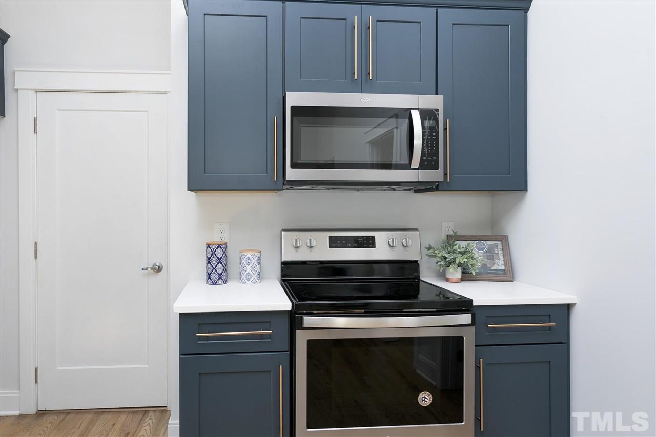 111 Bart Street Raleigh, NC 27610 - Photo 8 of 22 a kitchen with a stove and a microwave