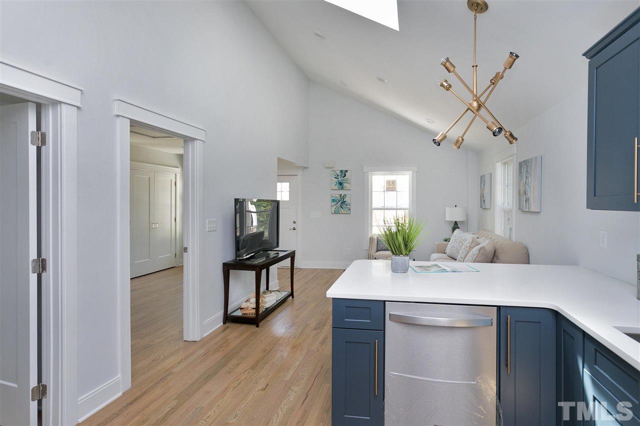 111 Bart Street Raleigh, NC 27610 - Photo 9 of 22 a kitchen with kitchen island a counter top space and wooden floor