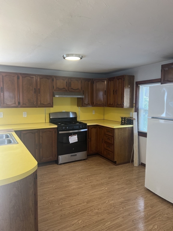 6 A Maple Avenue, Unit 6A Scituate, MA 02066 - Photo 6 of 21 a large kitchen with a stove a refrigerator a sink and dishwasher with wooden floor