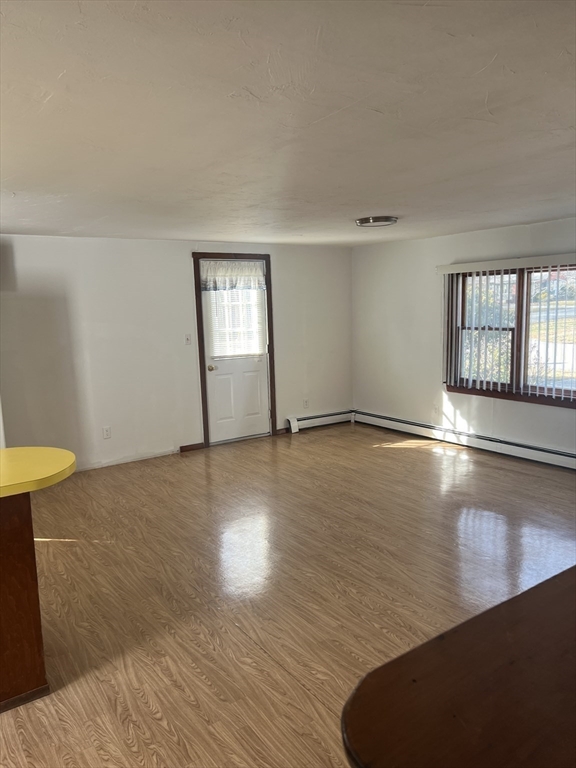 6 A Maple Avenue, Unit 6A Scituate, MA 02066 - Photo 8 of 21 a view of empty room with wooden floor and fan