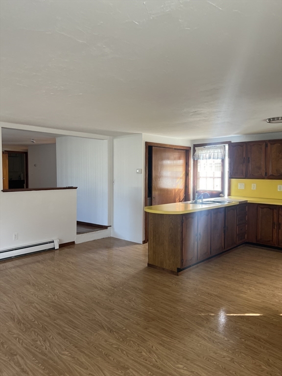 6 A Maple Avenue, Unit 6A Scituate, MA 02066 - Photo 10 of 21 a view of a big room with wooden floor and windows