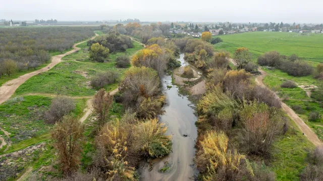 a view of lake with green space