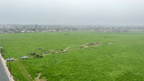 a view of a green field with clear sky