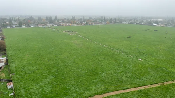 a view of a green field with clear sky