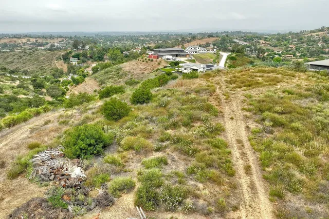 an aerial view of residential building and trees around