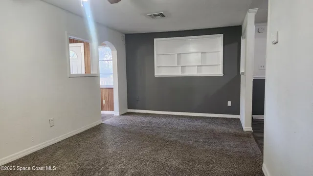 an empty room with windows and closet