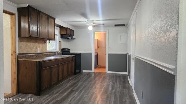 a kitchen with stainless steel appliances granite countertop a refrigerator a sink dishwasher a stove and a microwave oven on granite countertops