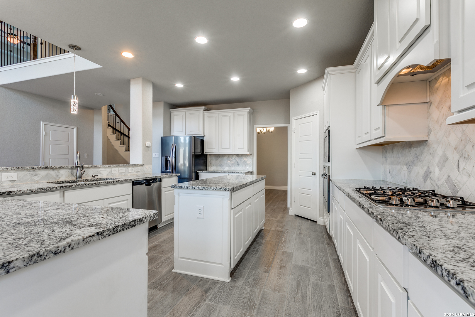 331 Ricadonna San Antonio, TX 78253 - Photo 11 of 28 a kitchen with granite countertop a sink stove refrigerator and cabinets