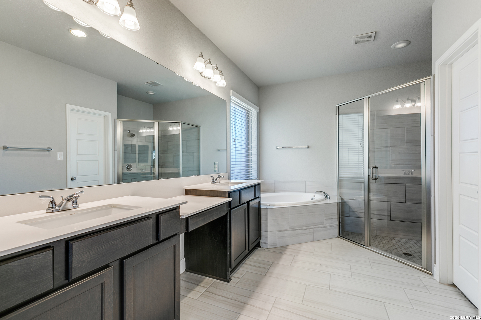 331 Ricadonna San Antonio, TX 78253 - Photo 15 of 28 a spacious bathroom with a granite countertop sink a toilet a mirror and shower