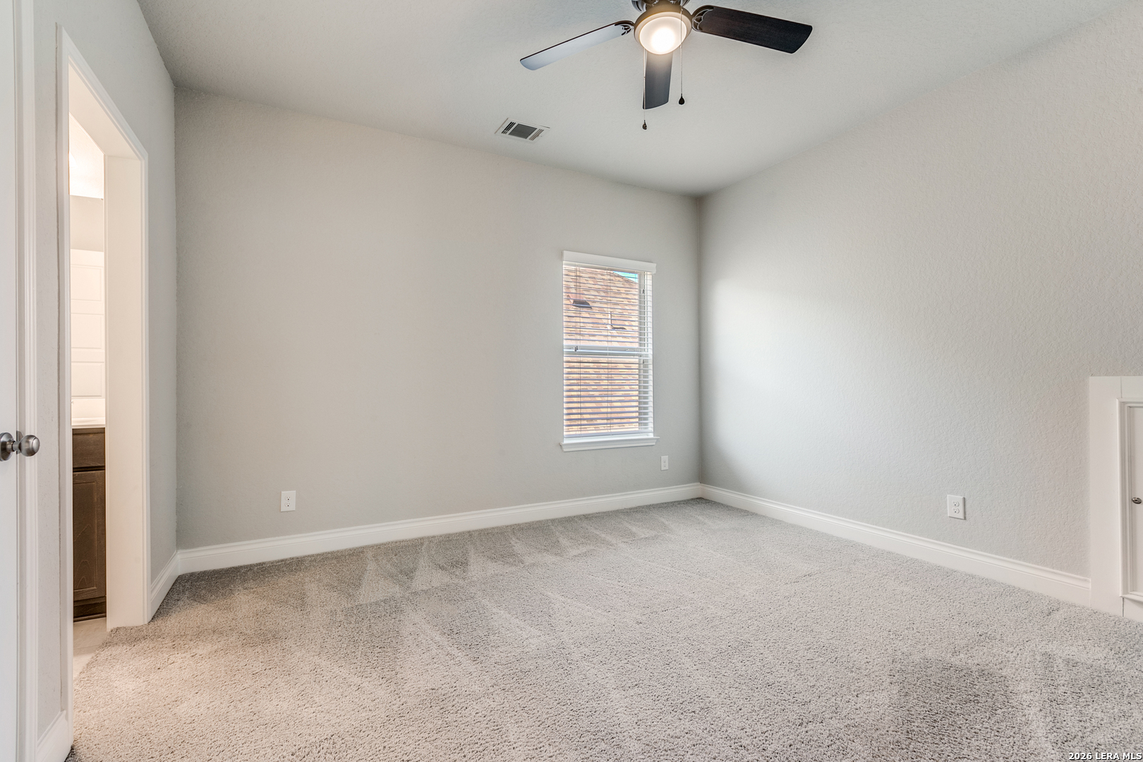 331 Ricadonna San Antonio, TX 78253 - Photo 21 of 28 an empty room with a chandelier fan and windows