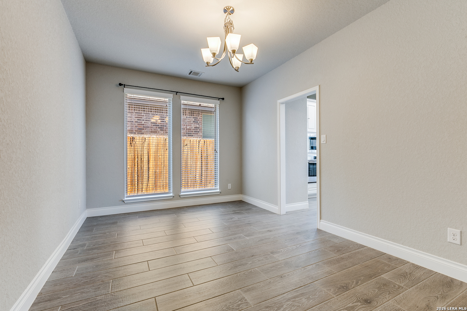 331 Ricadonna San Antonio, TX 78253 - Photo 5 of 28 a view of an empty room with wooden floor and a window