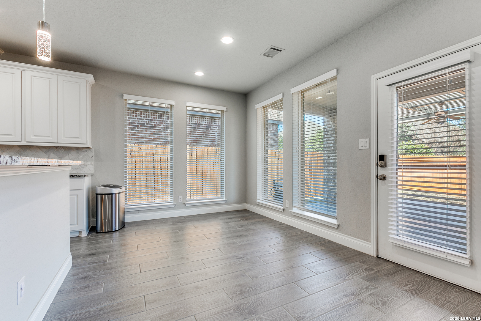 331 Ricadonna San Antonio, TX 78253 - Photo 9 of 28 a view of an empty room with a window and wooden floor