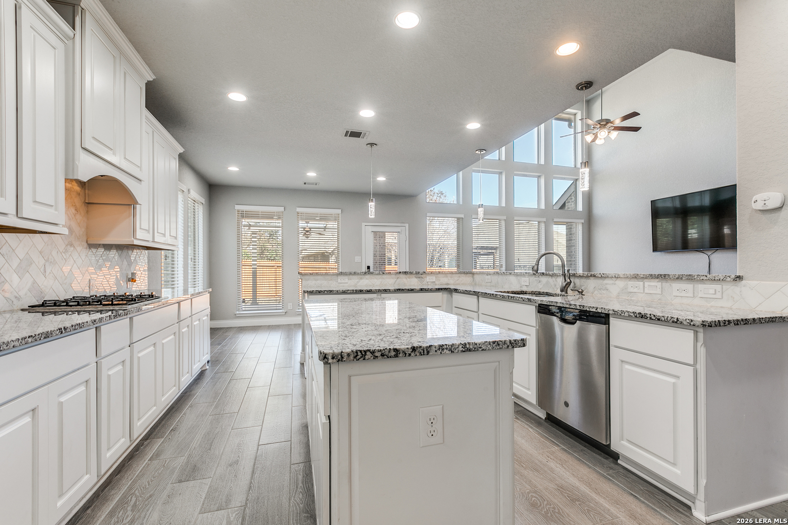 331 Ricadonna San Antonio, TX 78253 - Photo 10 of 28 a large kitchen with granite countertop a sink and a stove top oven